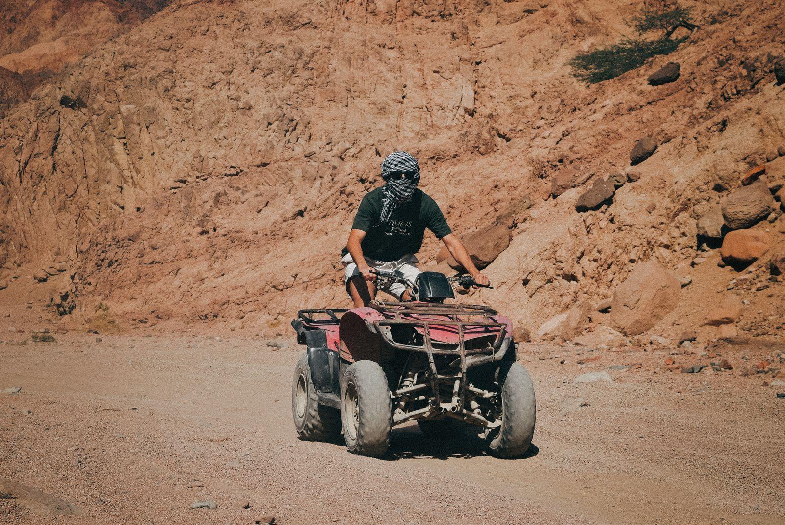 Quad bike rider in the desert near the Red Sea coast