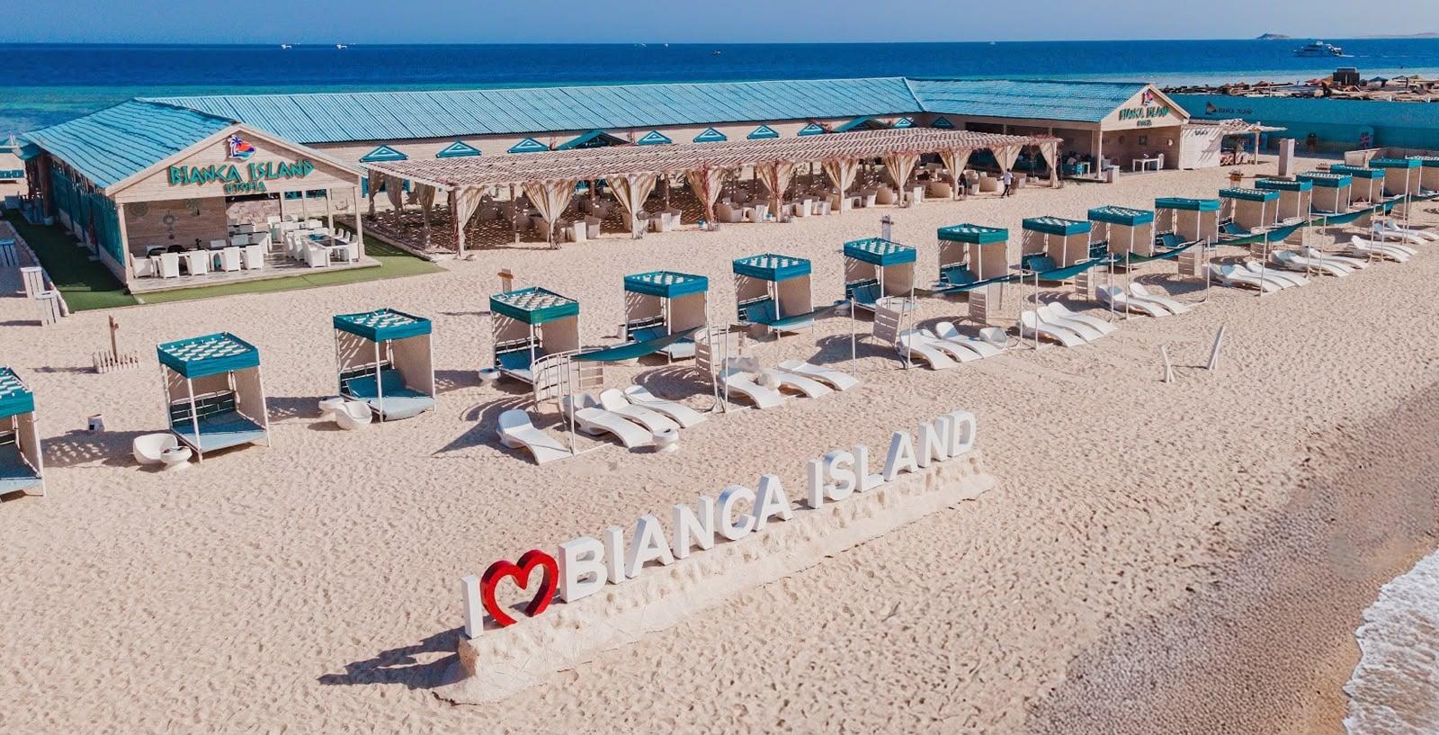 Bianca Island beach with shaded cabanas, white loungers and the I love Bianca Island sign by the Red Sea