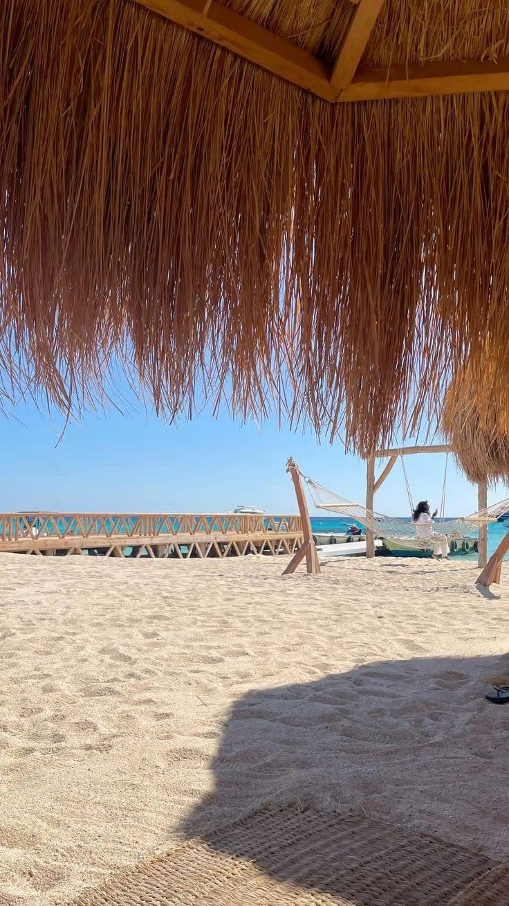 Beach shade and loungers looking out to the water at Hula Hula Island