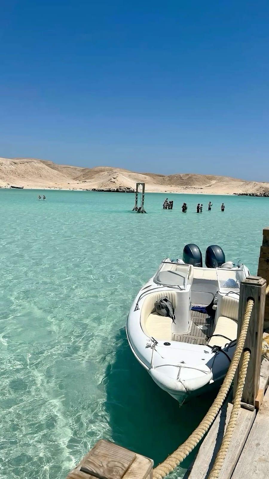 Speedboat moored in clear turquoise shallows at Orange Bay