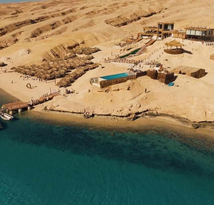 Aerial view of the Ozirea Island beach camp above the turquoise sea