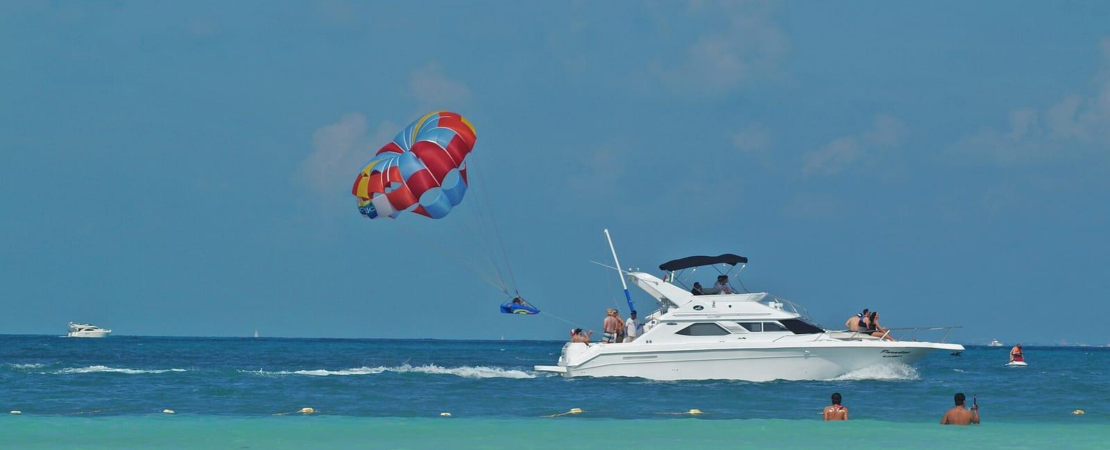 Parasail flying behind a speedboat over the sea